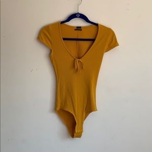 yellow short sleeve body suit